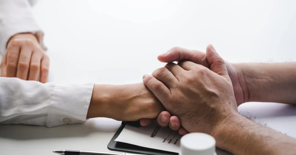 Healthcare provider holding a patient’s hand at an aesthetic practice in NY, symbolizing trust and care.